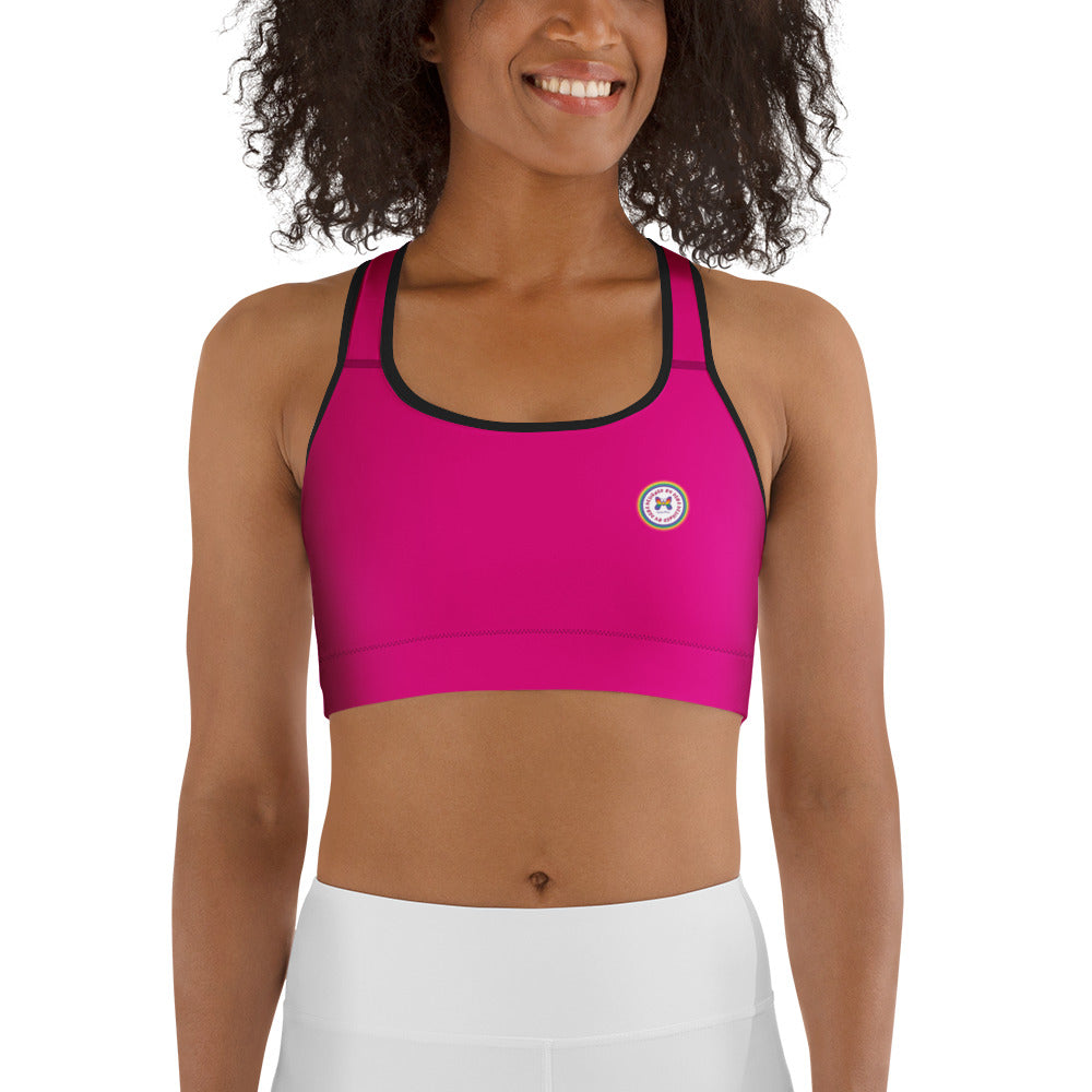 Hot pink all-over-print sports bra by Designed By Debz, front view showing vibrant black pattern, made to order in XS-2XL.