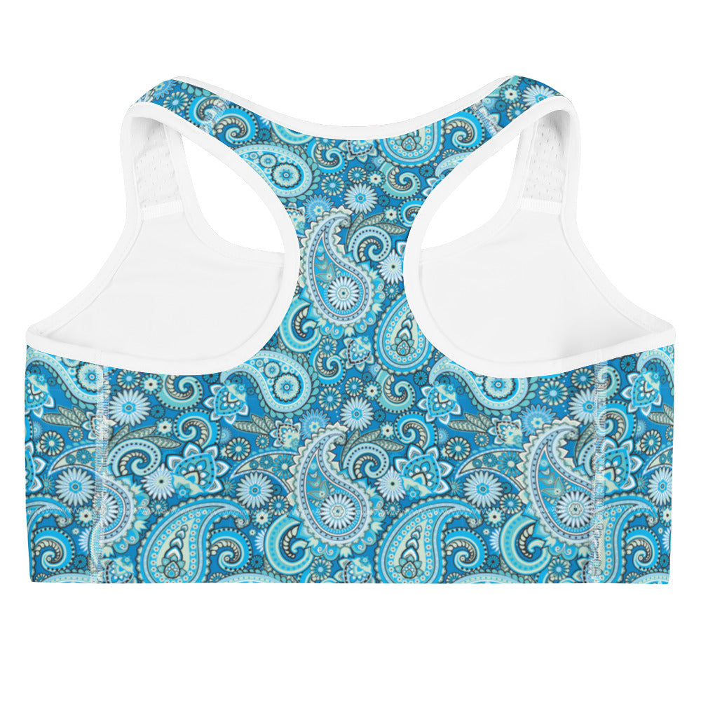 Blue paisley print sports bra from Printful, shown from the back with adjustable straps and all-over pattern in XS to 2XL sizes.