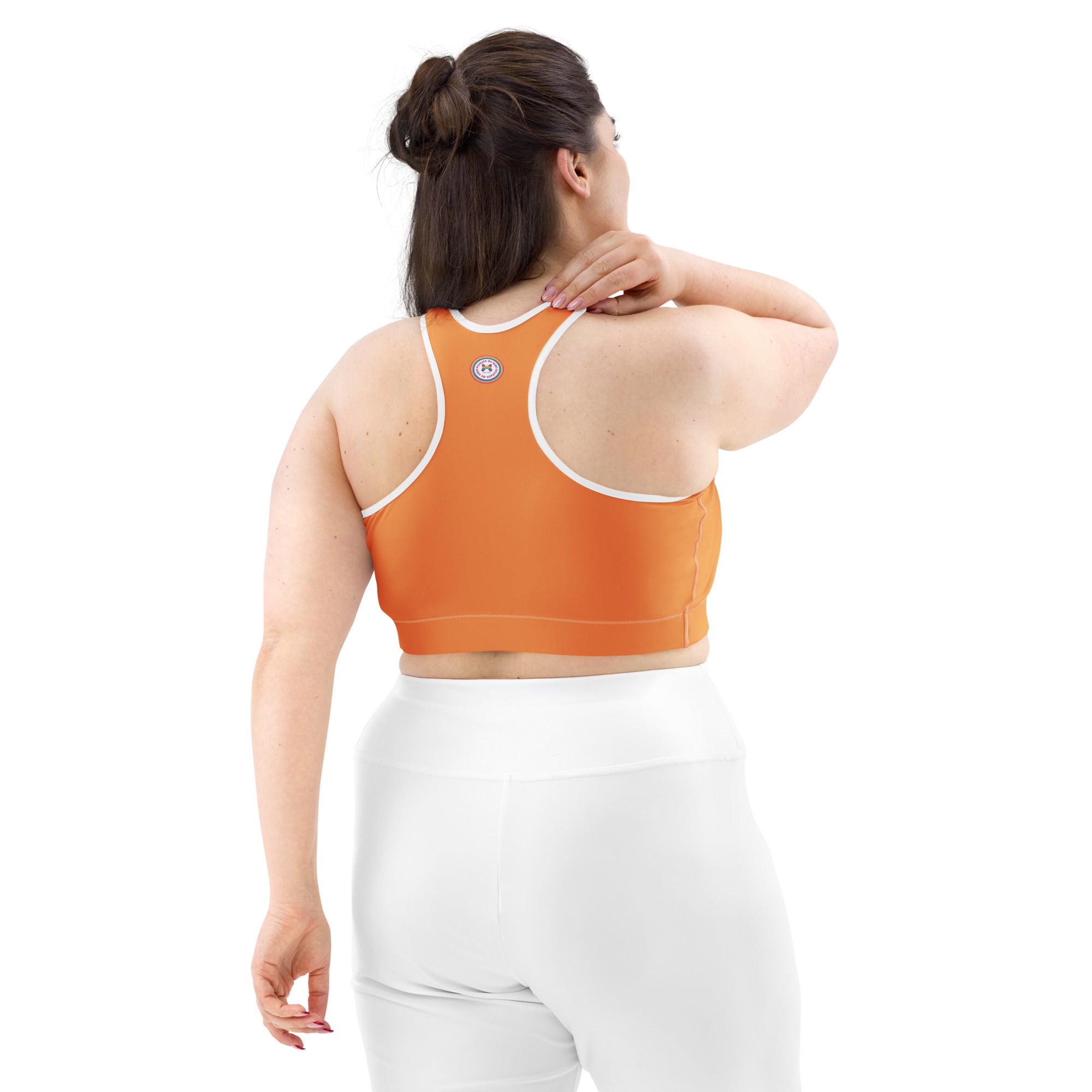 Printful sports bra with orange logo, black or white binding, all-over print design, back view, available in XS to 2XL.