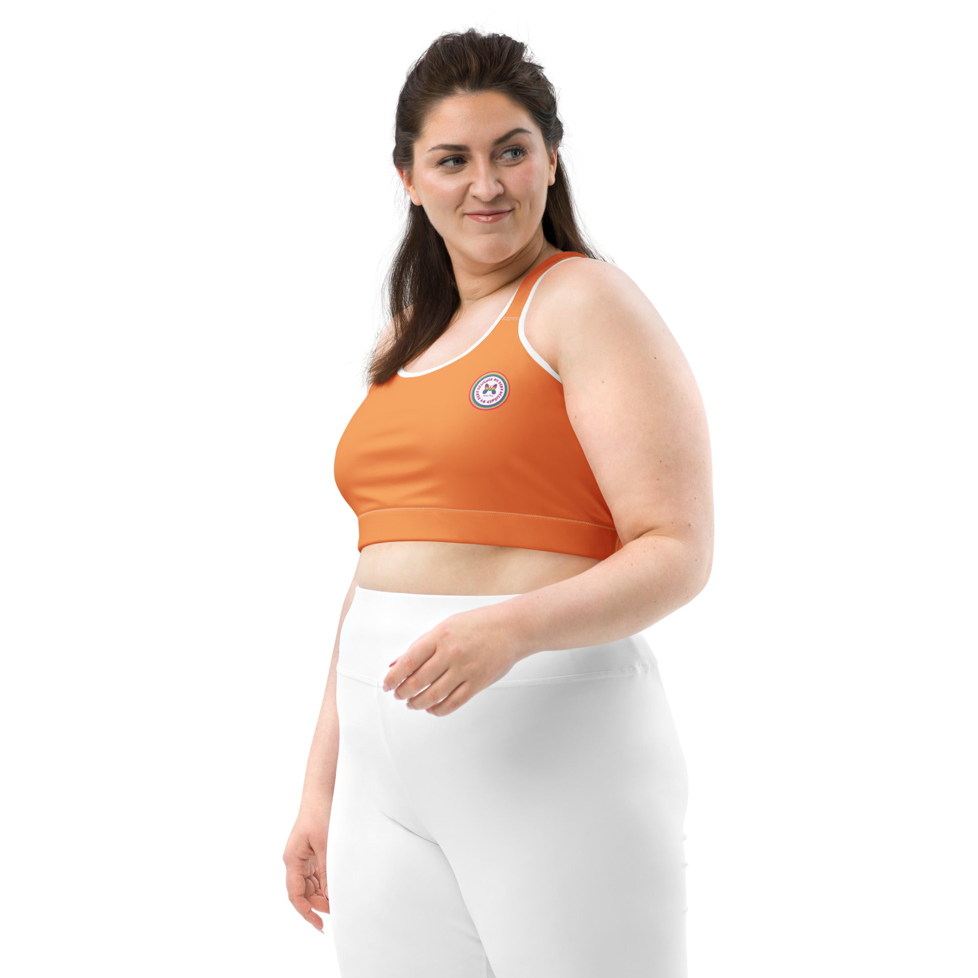 All-over-print black or white binding sports bra by Printful with orange logo, front view, available in XS to 2XL.