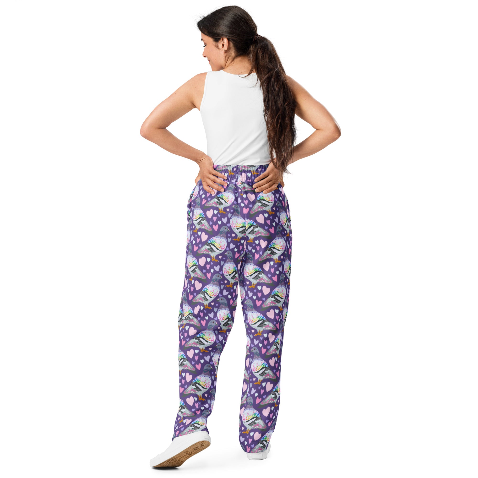 Unisex white wide-leg joggers with all-over pigeon love print by Printful, shown from the back.