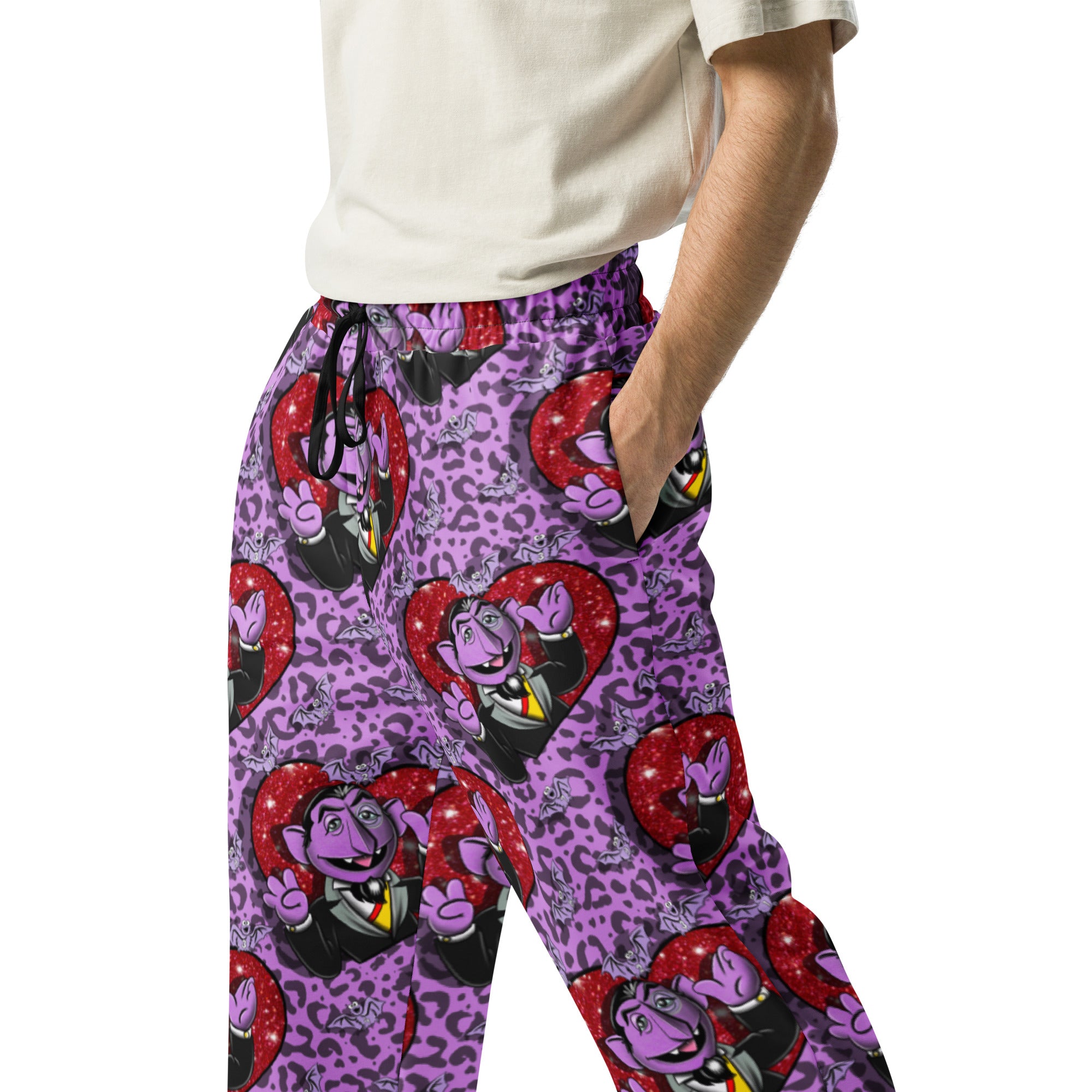Unisex white wide-leg joggers with all-over colorful print from Designed By Debz, casual comfortable streetwear.