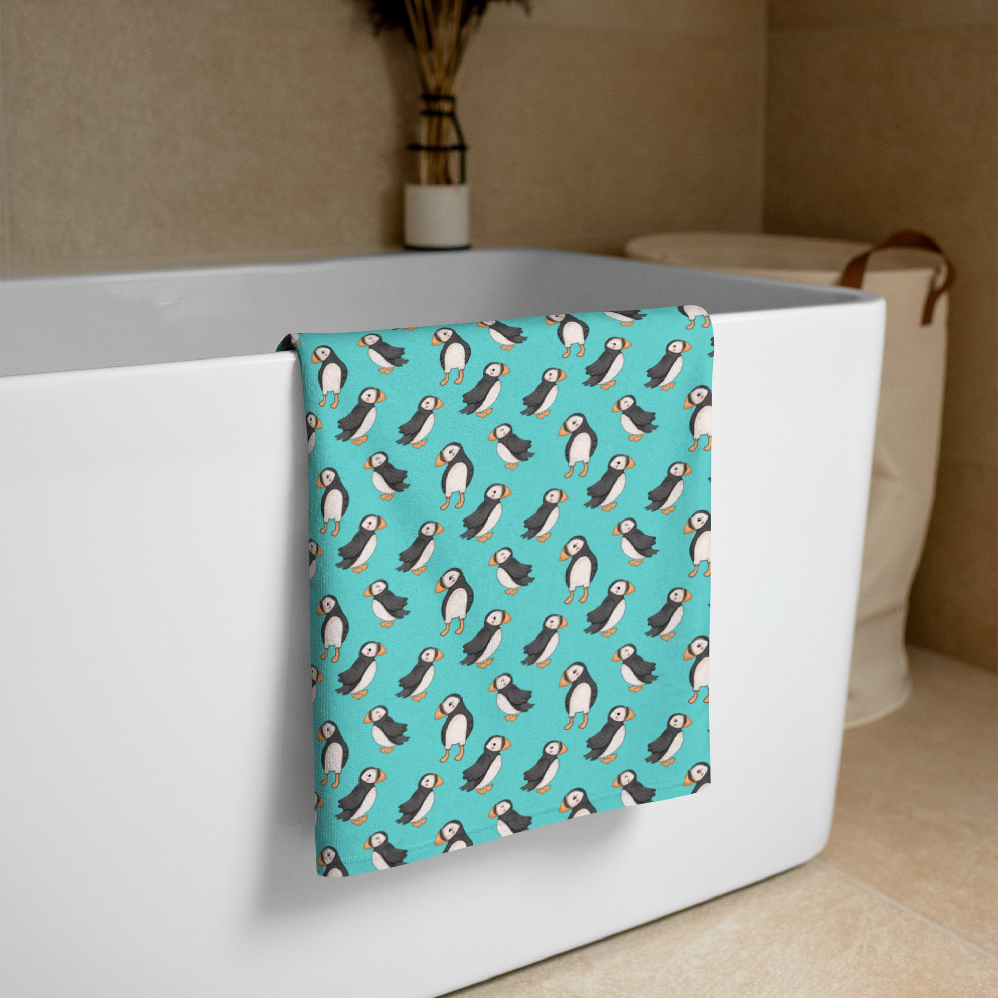 Extra large white Puffin Playtime beach towel displayed outdoors, showing soft fabric and vibrant print design.