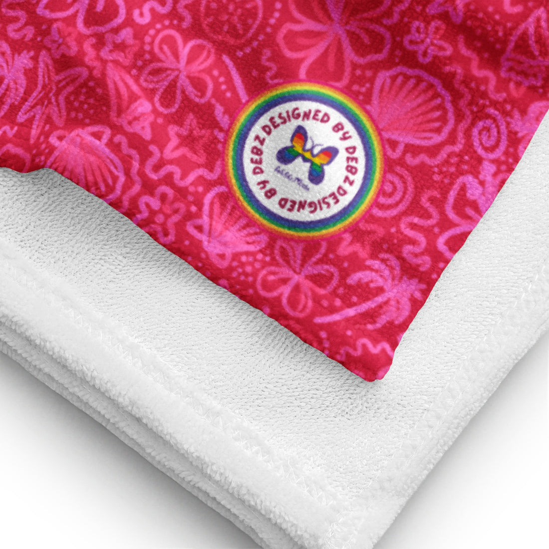 Bright pink seaside-themed towel by Designed By Debz featuring palm trees and floral patterns, perfect for beach days.