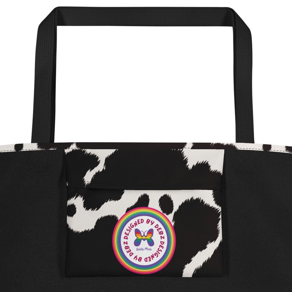 Black and white cow print tote bag by Designed By Debz, featuring a cute cow pattern and spacious shopper design.