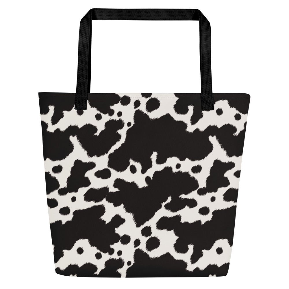 Black and white cow print tote bag by Designed By Debz, featuring a playful cow pattern and durable shopper design.