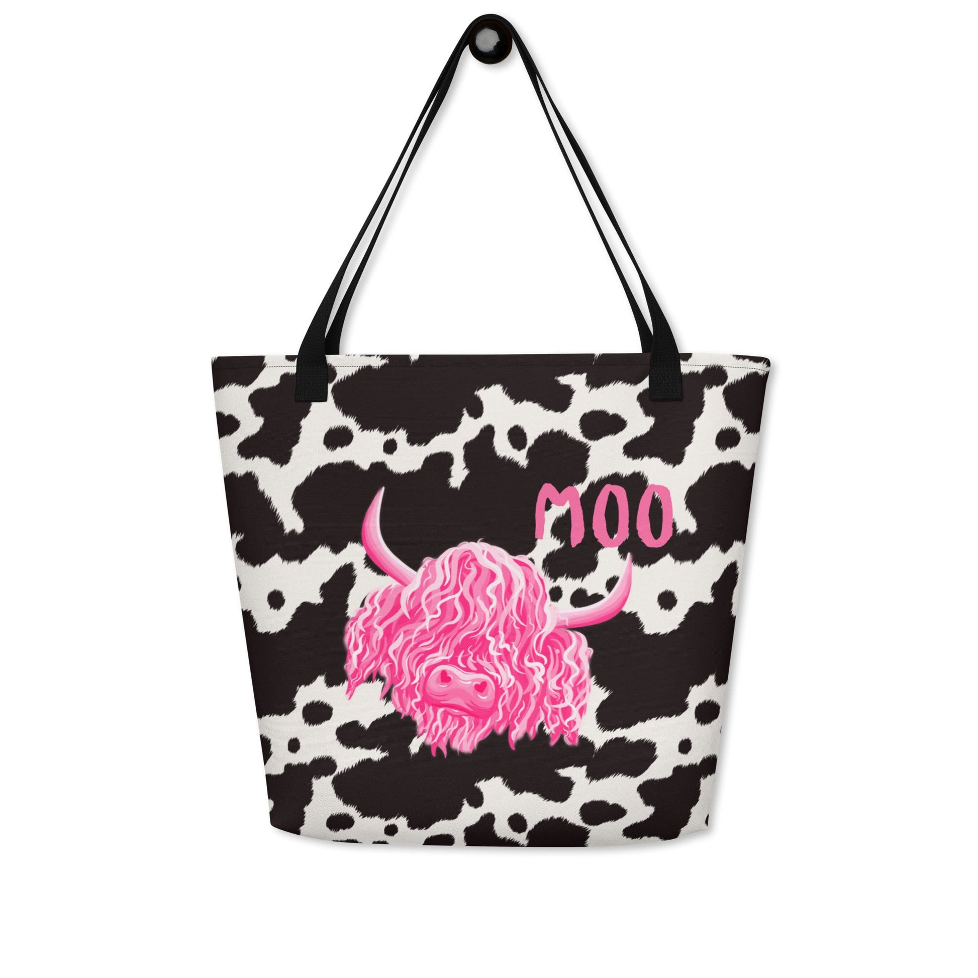 Black and white cow print tote bag by Designed By Debz, featuring a cute cow shopper bag with bold cow print pattern.