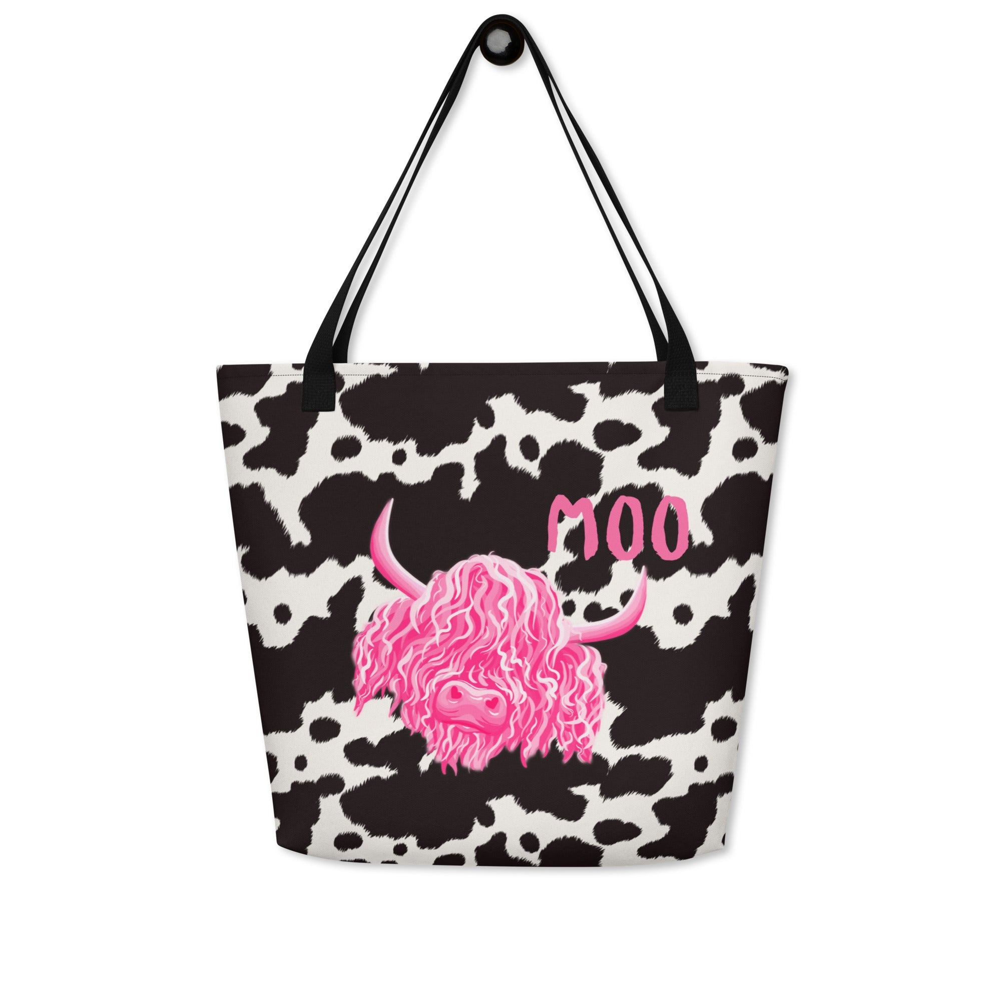 Black and white cow print tote bag by Designed By Debz, featuring a cute cow shopper bag with bold cow print pattern.