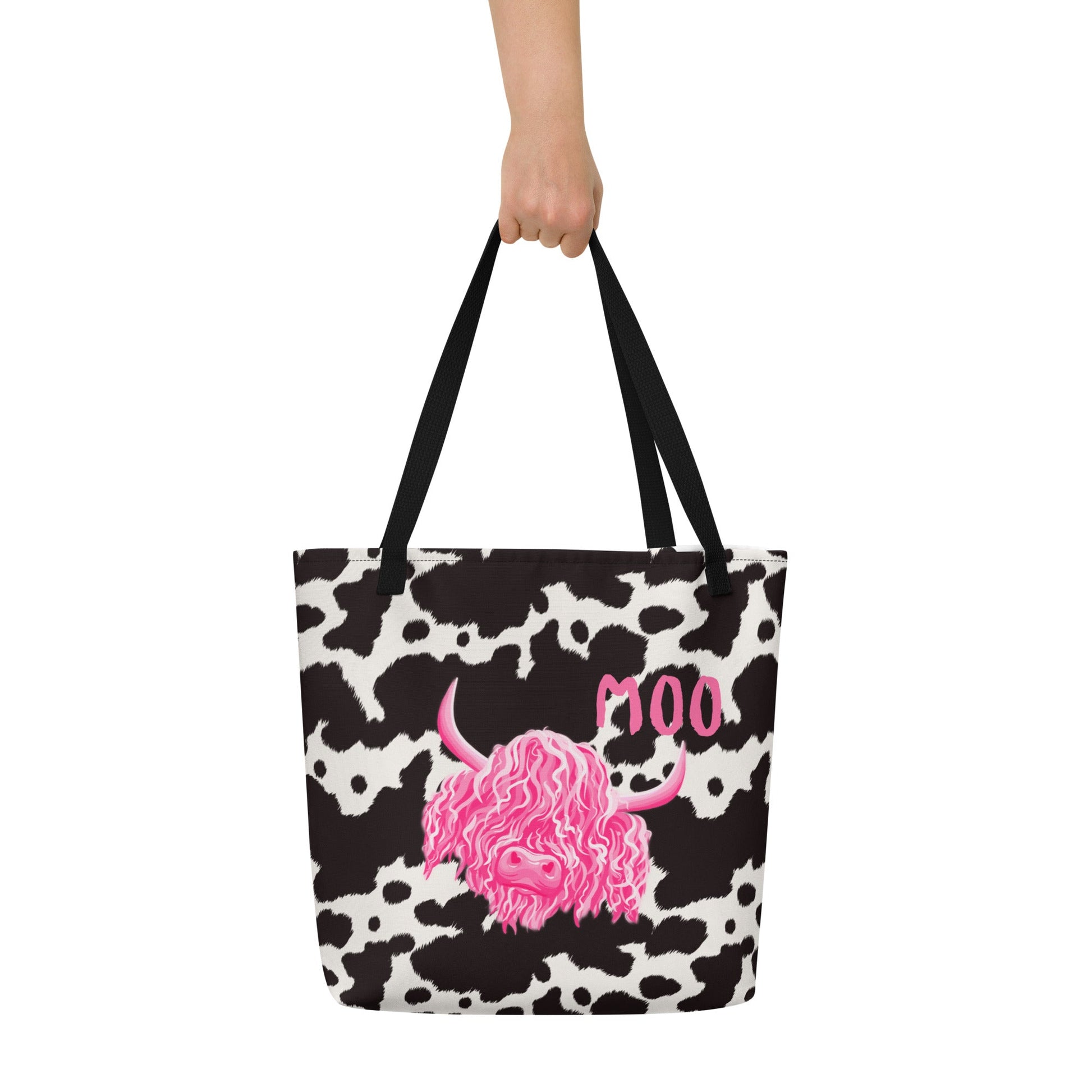 Black and white cow print tote bag by Designed By Debz, featuring a spacious shopper design with playful cow pattern.
