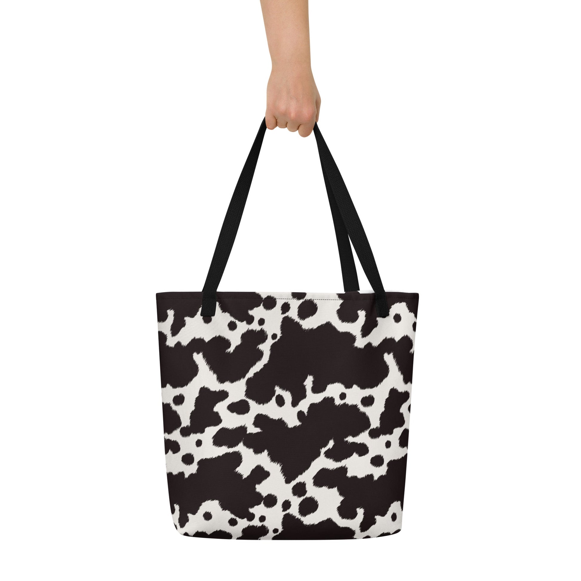 Black and white cow print tote bag by Designed By Debz, featuring a cute cow design and spacious shopper style.