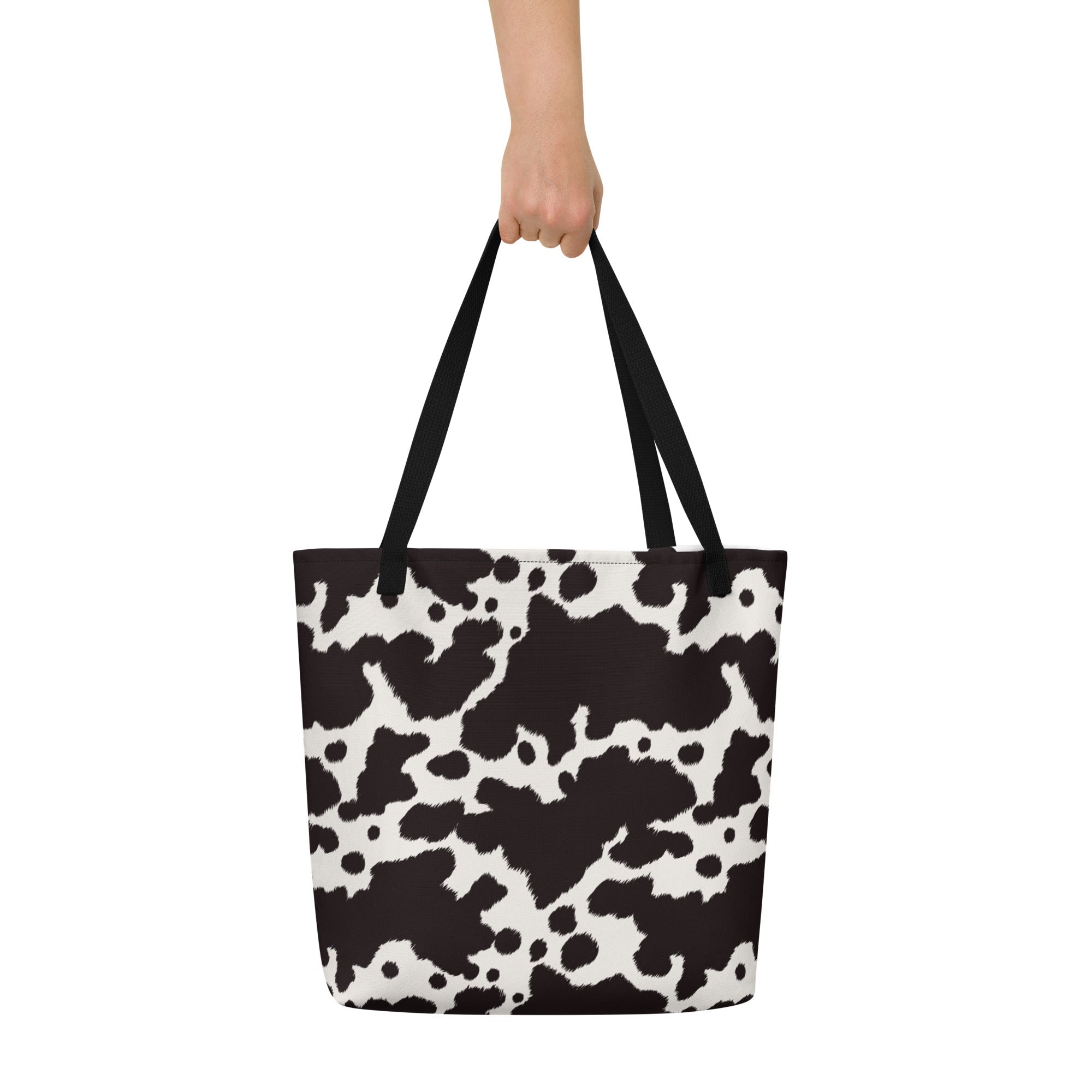 Black and white cow print tote bag by Designed By Debz, featuring a cute cow design and spacious shopper style.