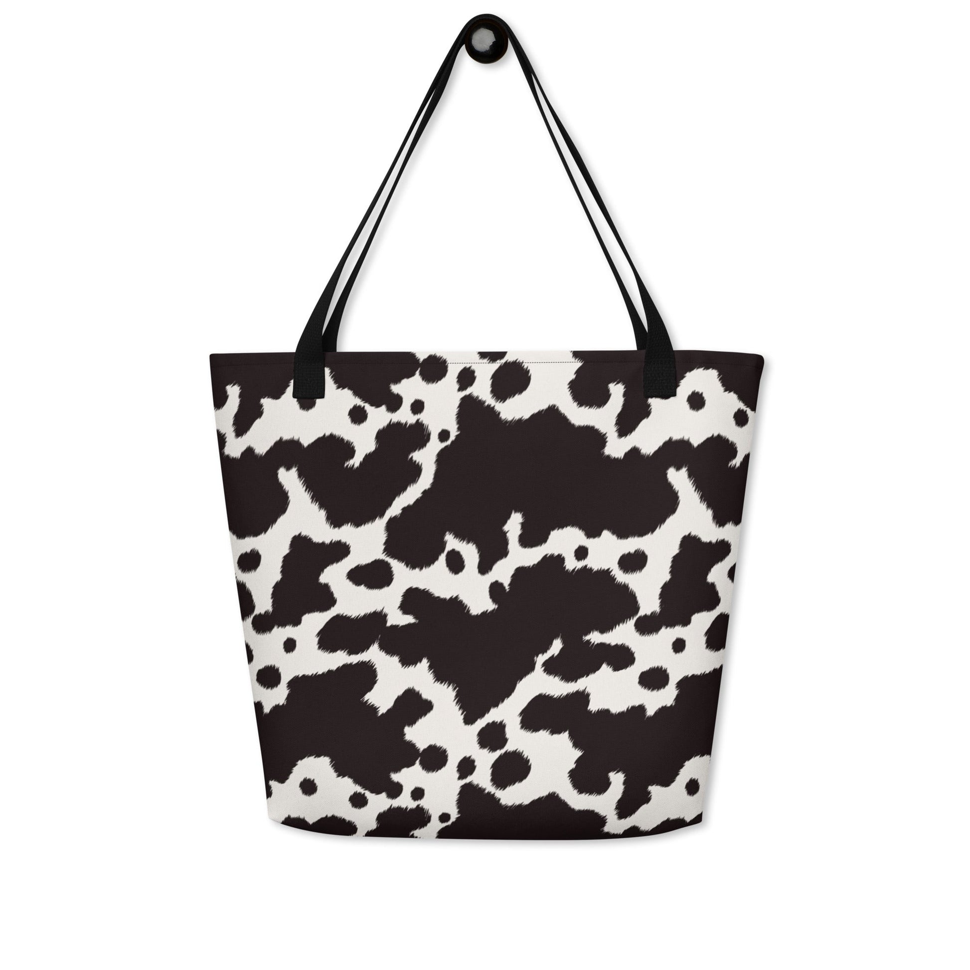 Black and white cow print tote bag by Designed By Debz, featuring a spacious and stylish cow-themed shopper bag.