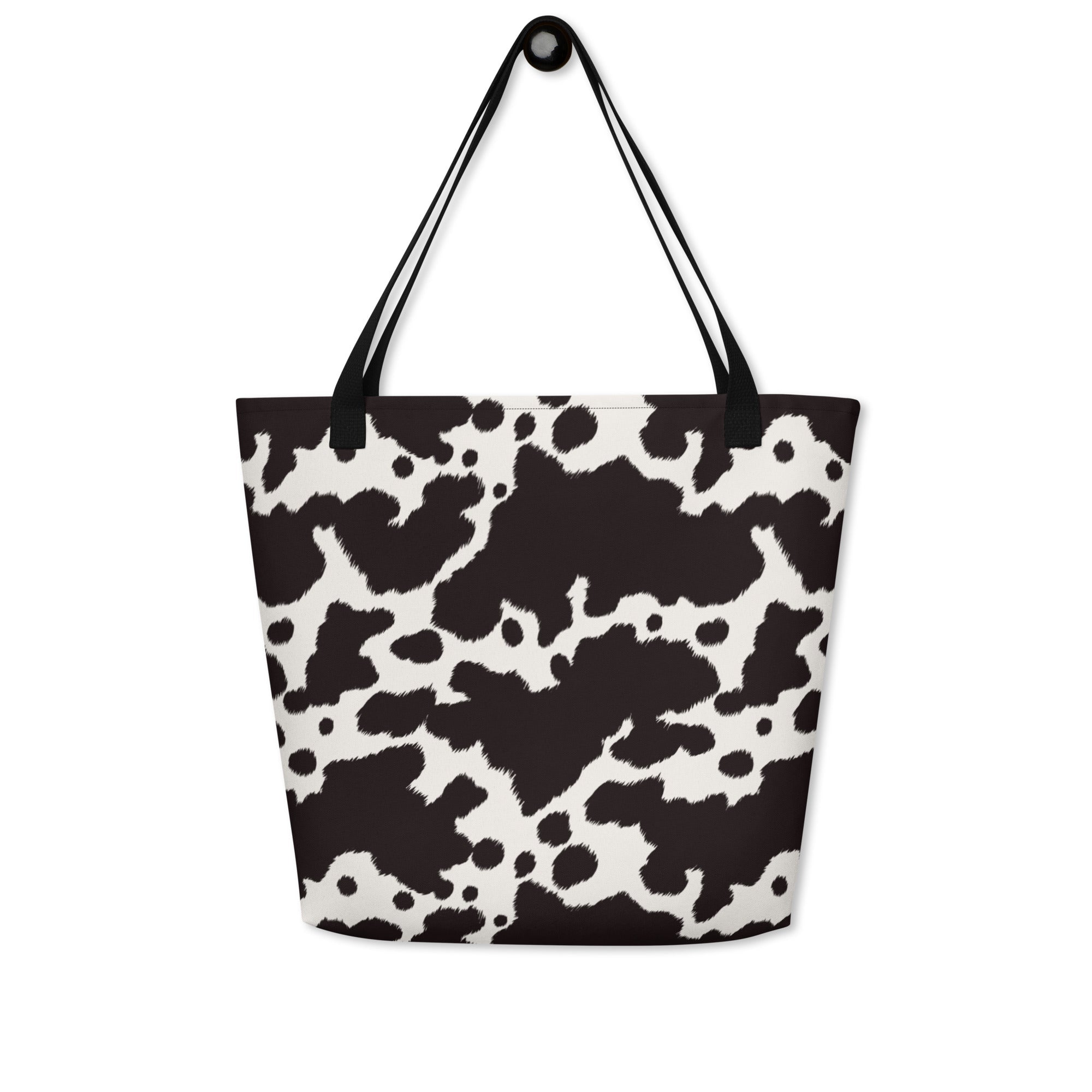 Black and white cow print tote bag by Designed By Debz, featuring a spacious and stylish cow-themed shopper bag.