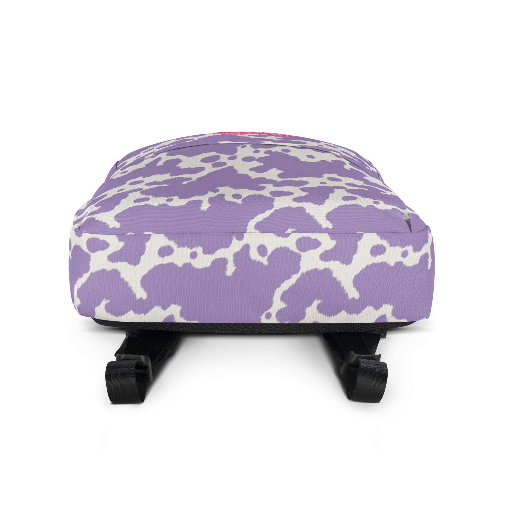 Lilac cow print backpack by Designed By Debz featuring a cute pink cow design, ideal for carrying laptops and everyday essentials.