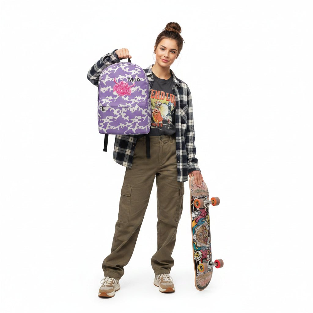 Lilac cow print backpack by Designed By Debz featuring pink cow pattern, perfect for carrying a laptop in a cute, stylish design.