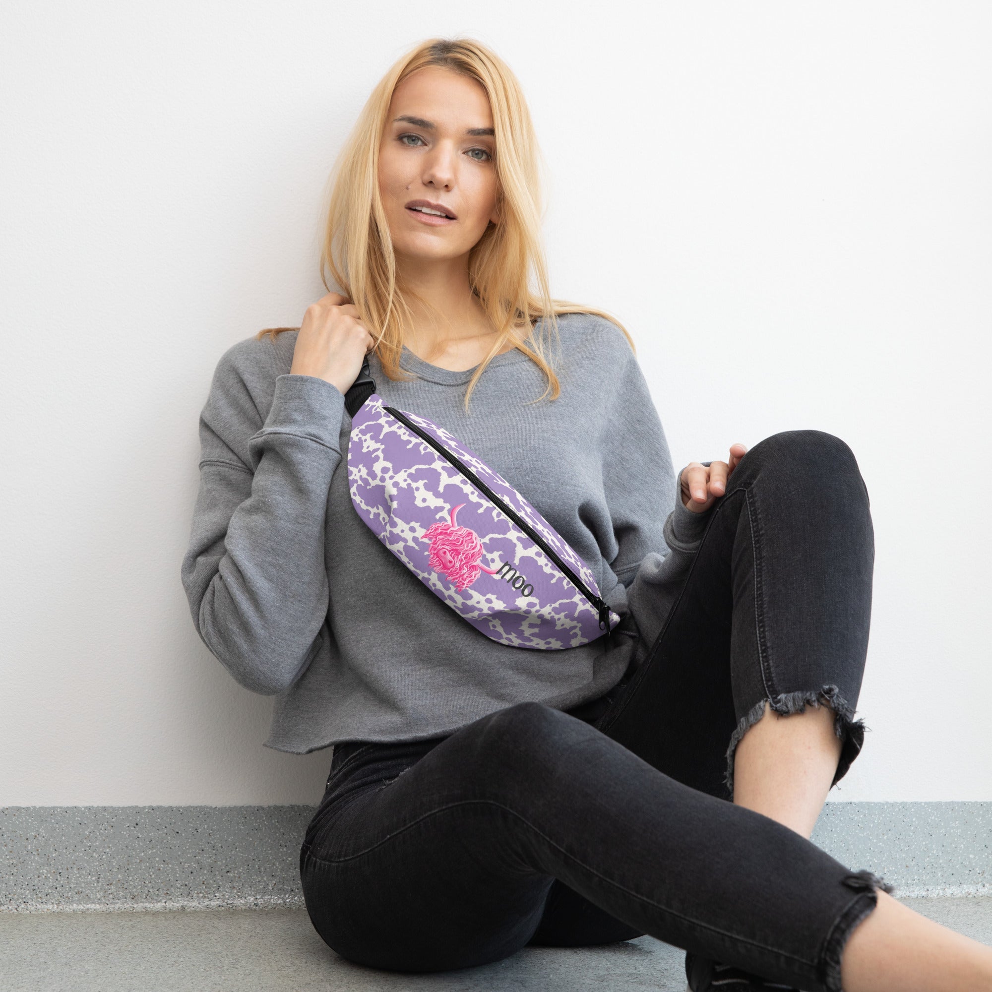 Lilac cow print bum bag by Printful with cute pink cow design, stylish fanny pack with adjustable strap and cow pattern.