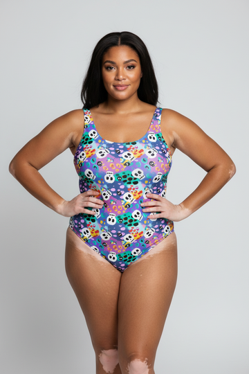 Leopard print skulls swimsuit by Printful, recycled one-piece with UPF 50+ sun protection, shown on a model.