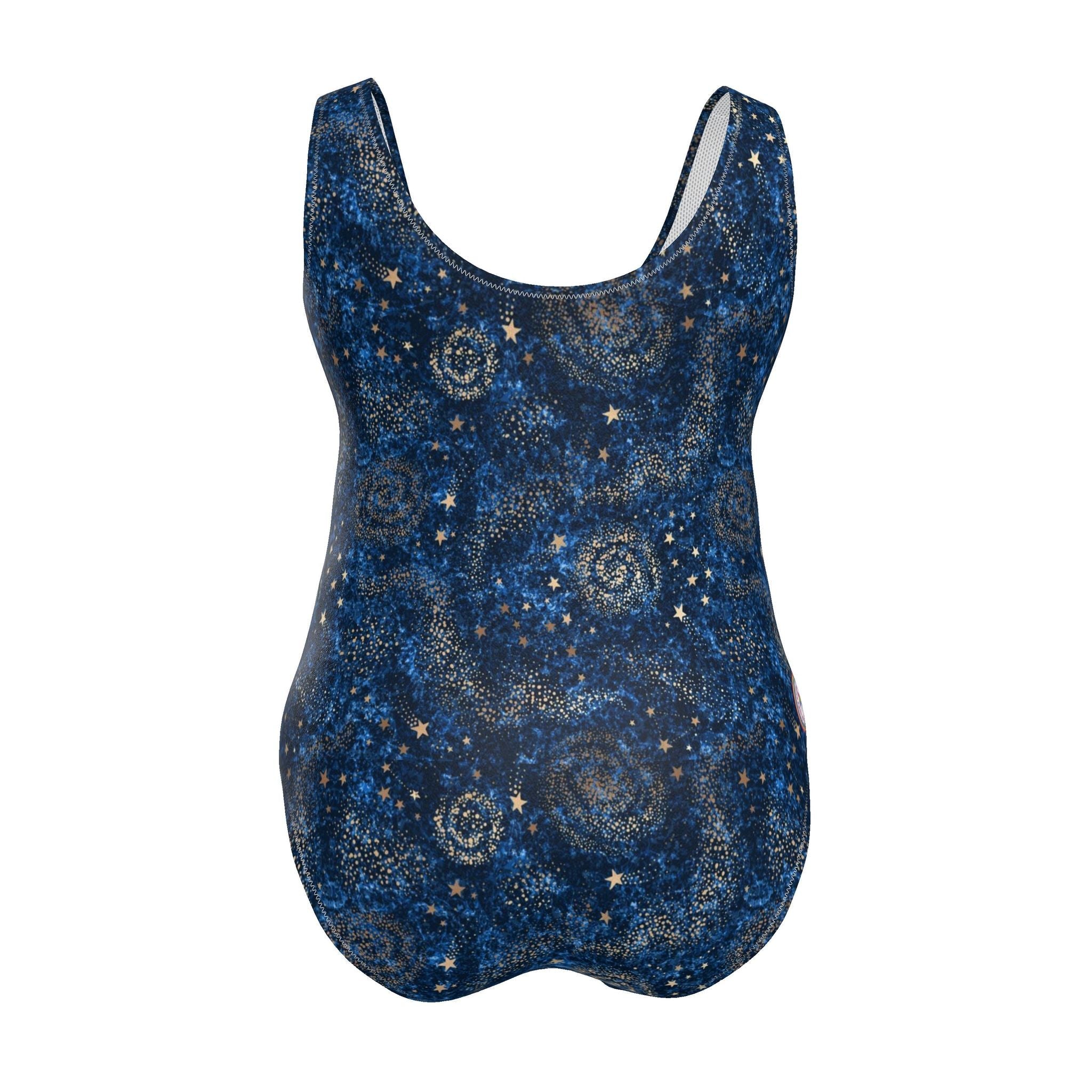 A woman modeling a one-piece swimsuit with a dark blue and black celestial print featuring stars and swirls, set against a solid light blue background.