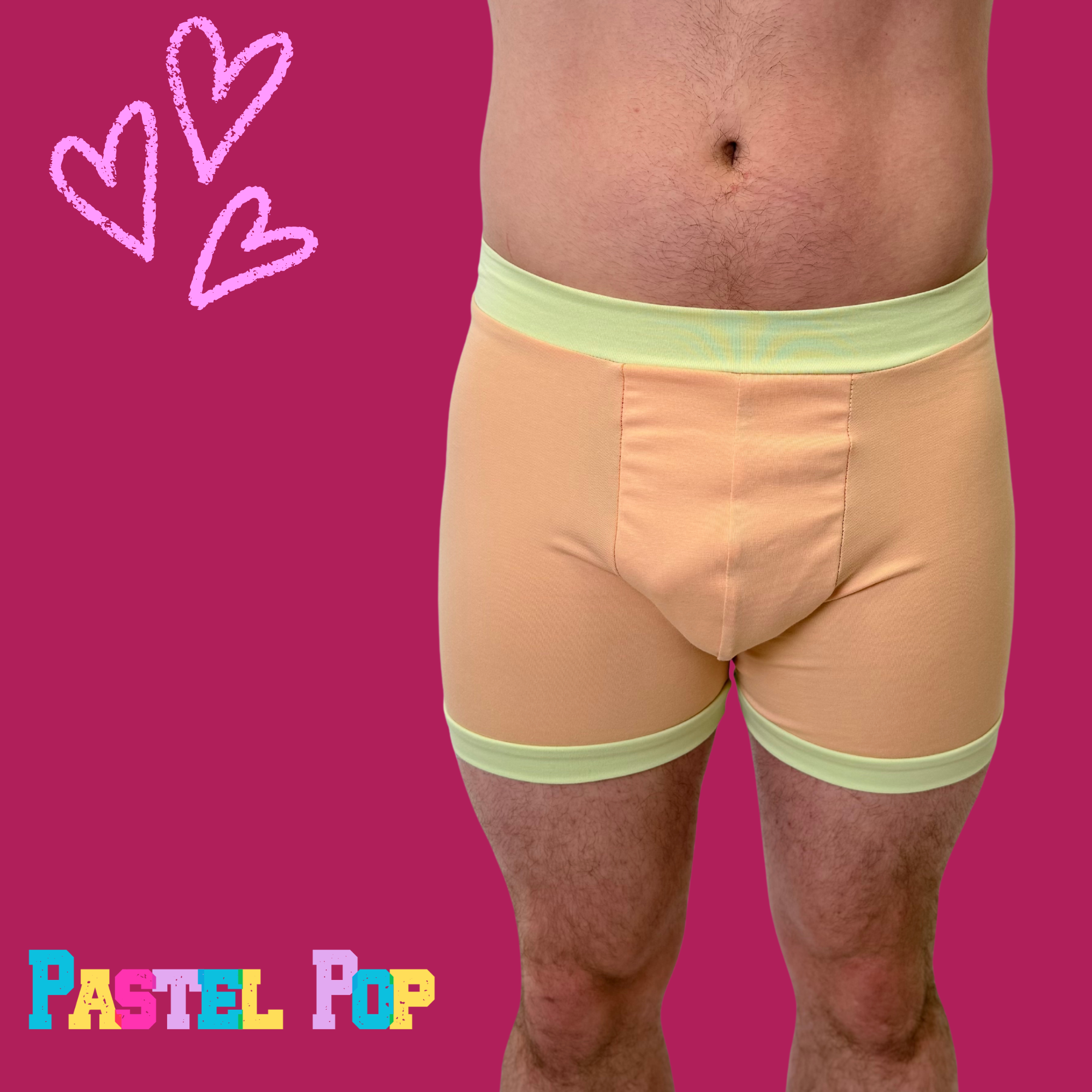 Comfort Boxers by Designed By Debz in pastel orange and green, made from organic cotton, featuring a relaxed fit and vibrant colors.