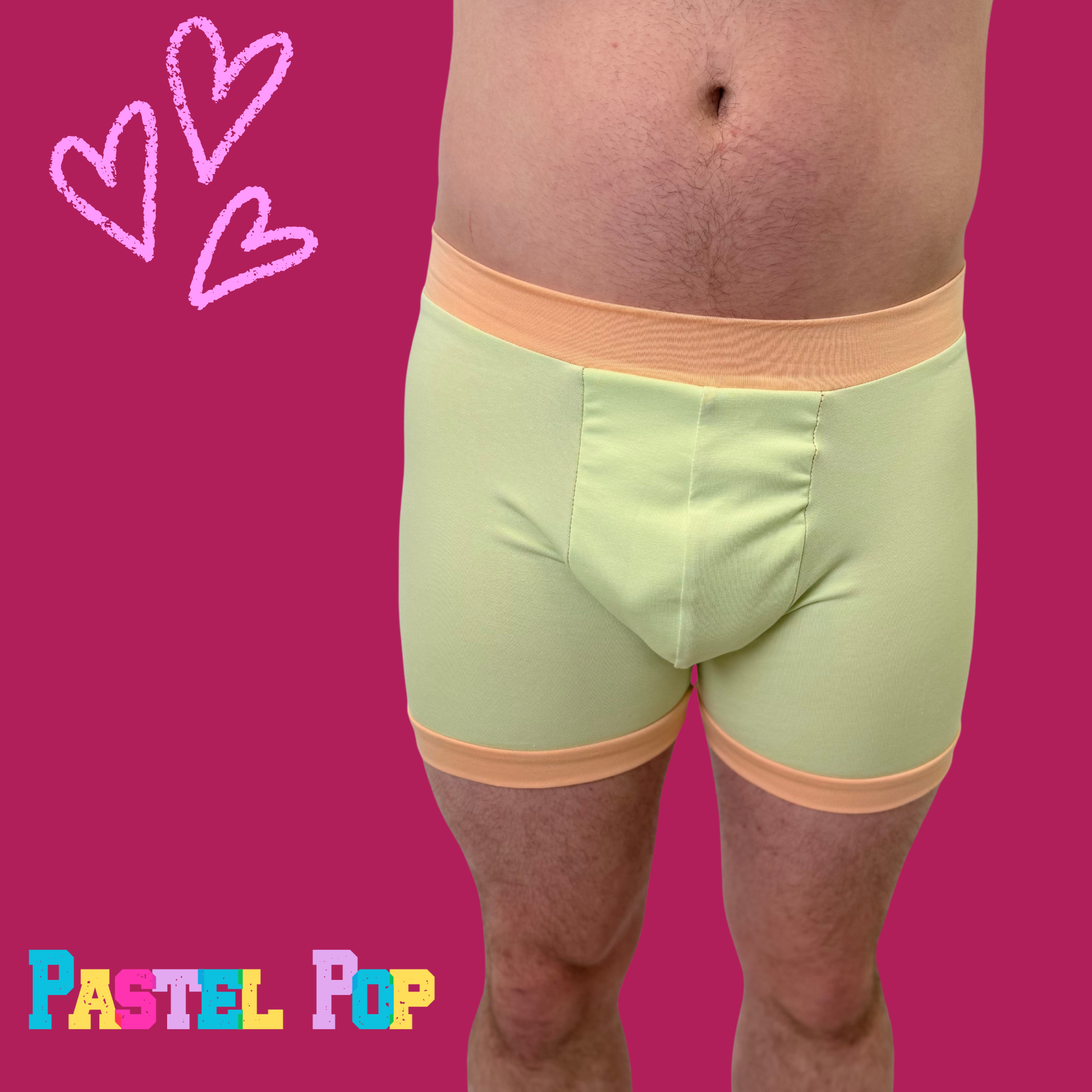 Comfort Boxers by Designed By Debz in pastel green and orange, made from organic cotton, featuring a relaxed fit and vibrant colors.